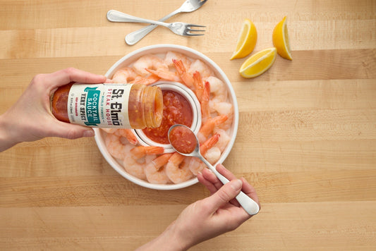 a tray of shrimp with a jar of St. Elmo Cocktail Sauce from the jar