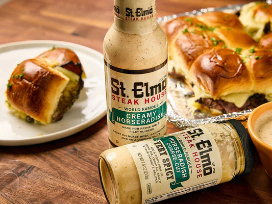Warm roast beef sliders with melted Swiss cheese on Hawaiian rolls served with St. Elmo Creamy Horseradish and Coarse-Cut Horseradish.