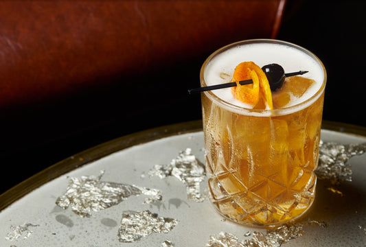 Whiskey sour with orange peel and cherry 