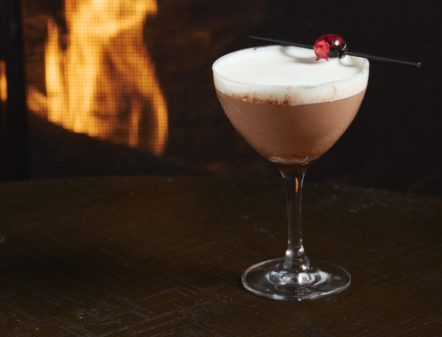 Bourbon Chocolate Martini in front of a fireplace 