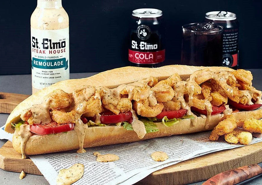 Shrimp po'boy sandwich loaded with crispy fried shrimp, lettuce, tomato, and remoulade sauce on French bread.