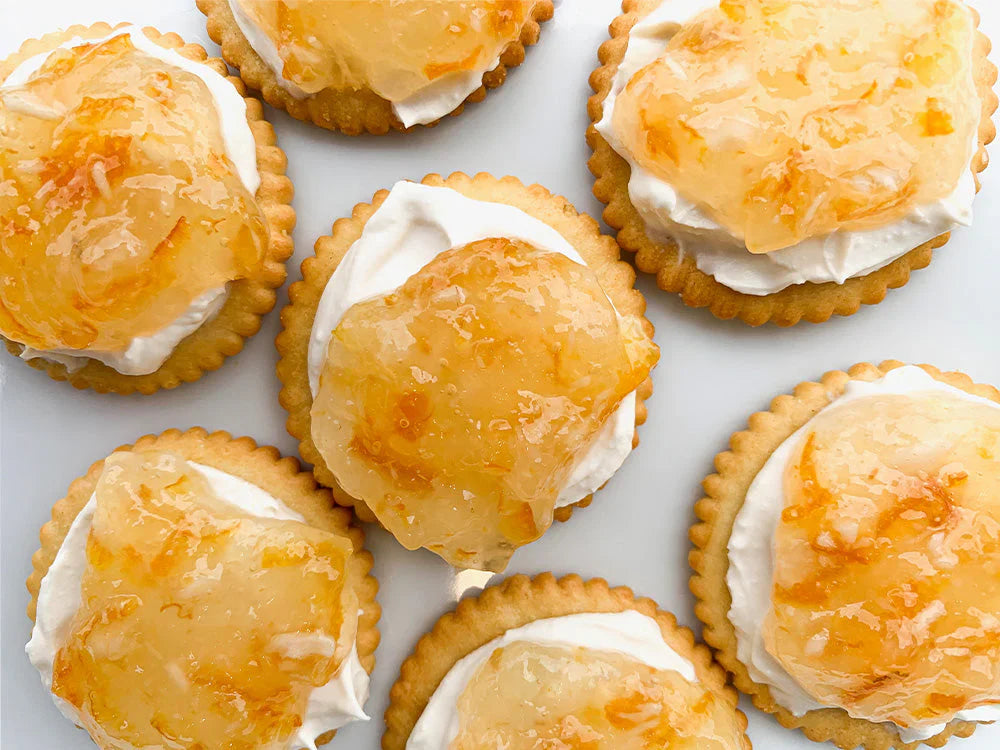 Cream cheese and orange marmalade cracker appetizers topped with spicy horseradish spread.